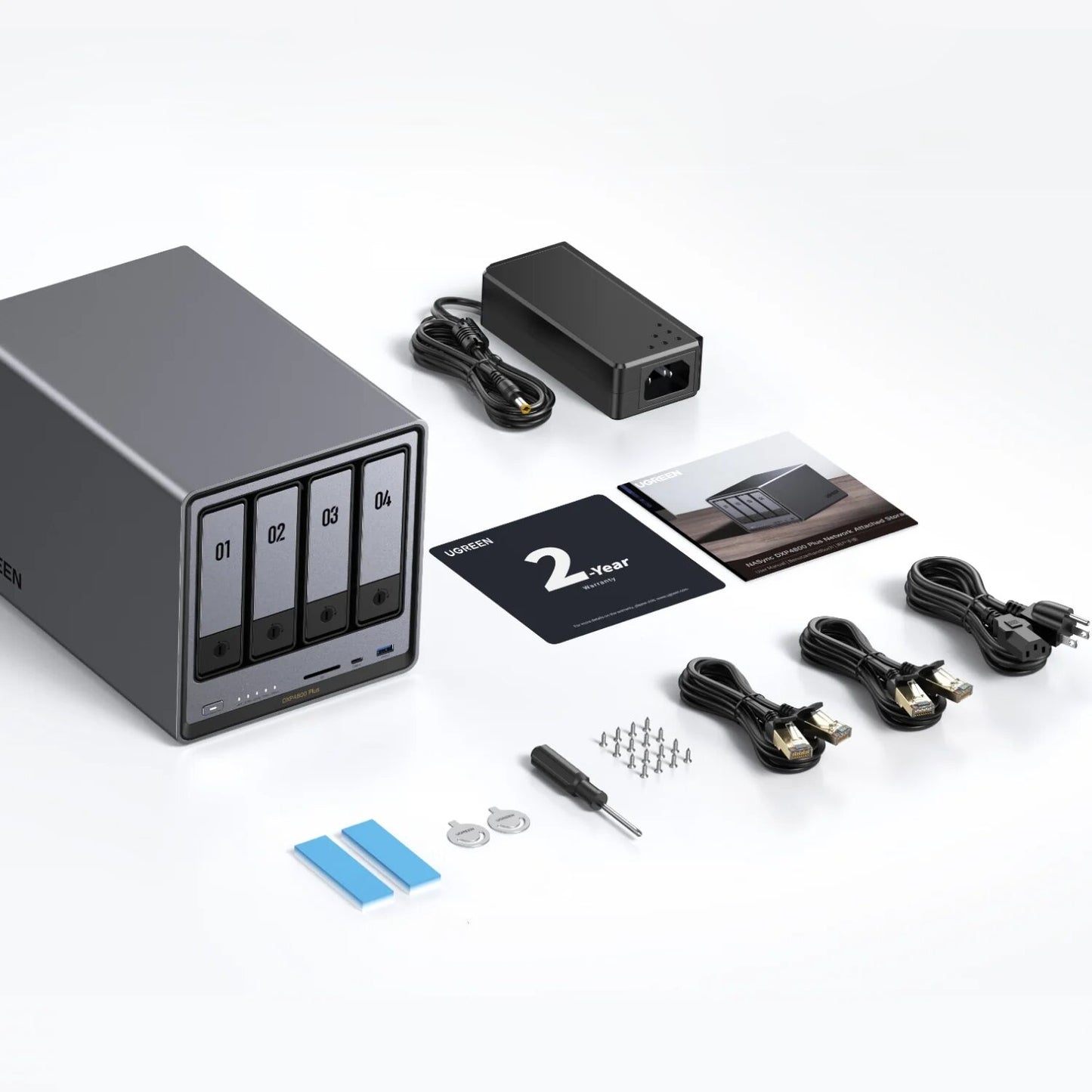 Computer hardware kit with hard drive, power adapter, cables, and screws on a white background