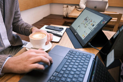 Image of a person working at a desk with a laptop and the Novus screen as a second display