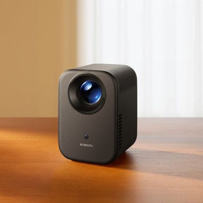 Xiaomi projector on a wooden surface with a neutral background