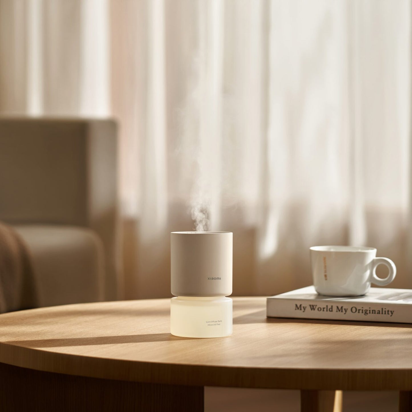Xiaomi Smart Scent Diffuser and mug on a wooden table with a blurred background