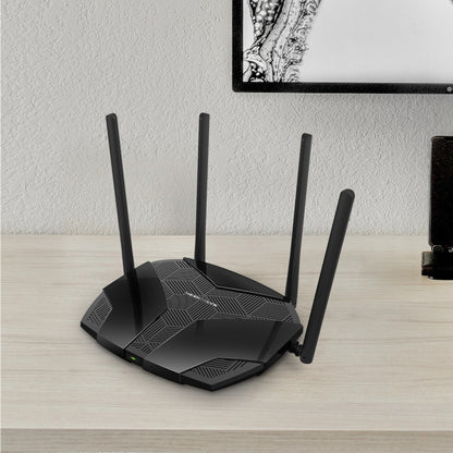 Mercusys MR70X AX1800 Dual-Band WiFi 6 Router placed on a wooden desk in a modern home setting, showing four antennas and sleek black geometric design.