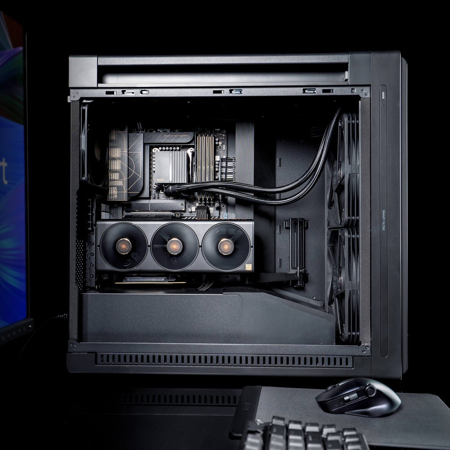 Open computer case with visible hardware components on a black background