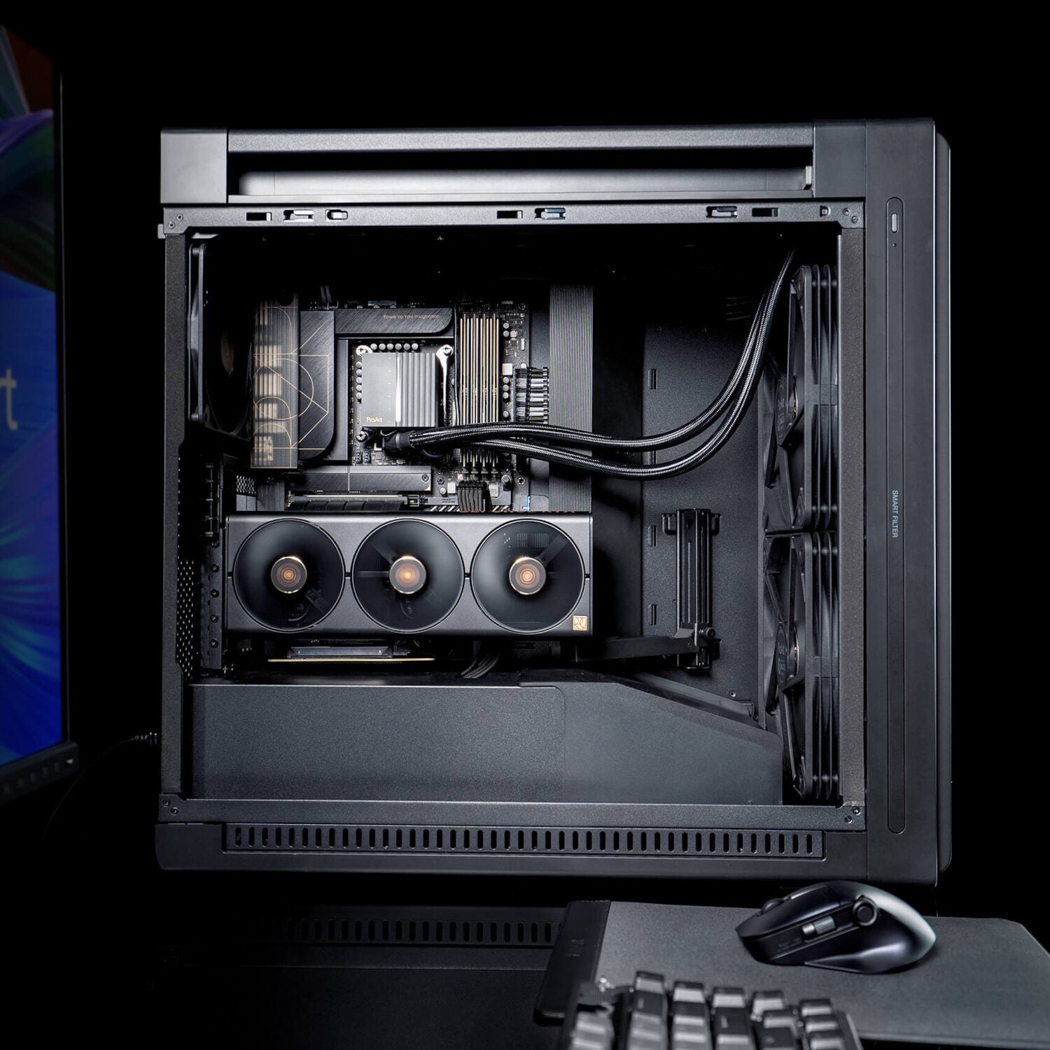 Open computer case with visible hardware components on a black background