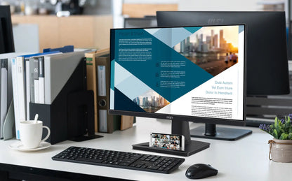 Computer setup on a desk with a monitor displaying a cityscape, keyboard, and mouse.