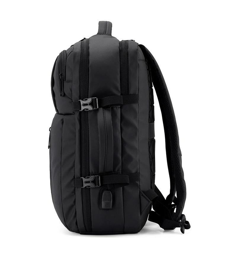 Side view of black adjustable laptop backpack with dual compression straps, USB charging port, and padded shoulder straps – fits 13″ to 17″ laptops.