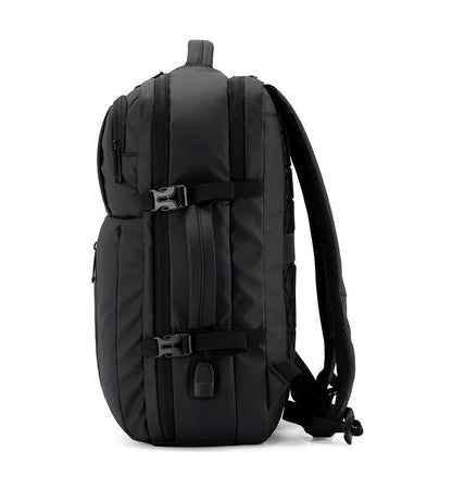 Side view of black adjustable laptop backpack with dual compression straps, USB charging port, and padded shoulder straps – fits 13″ to 17″ laptops.