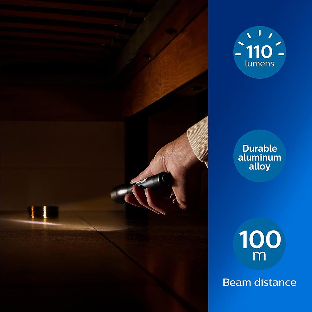 Philips SFL4002T/10 LED torch in hand; 110 lumens, 100 m beam, includes 2 AA batteries, durable aluminum body.