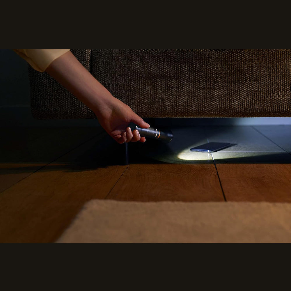 Philips LED Torch SFL7000T/10, 400-lumen, under sofa illuminates a smartphone on the floor