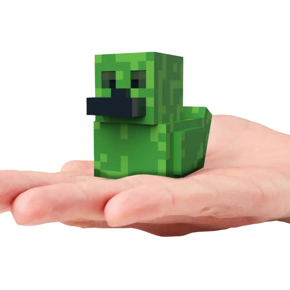The Tubbz Minecraft Mini Creeper in the shape of a duck held in a hand on a white background
