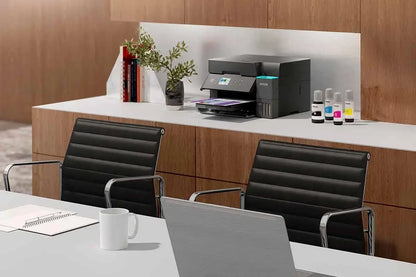 Modern office setup with a desk, chairs, and printer.