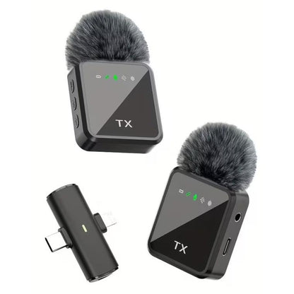 Two wireless microphone transmitters with fur windshields on a white background
