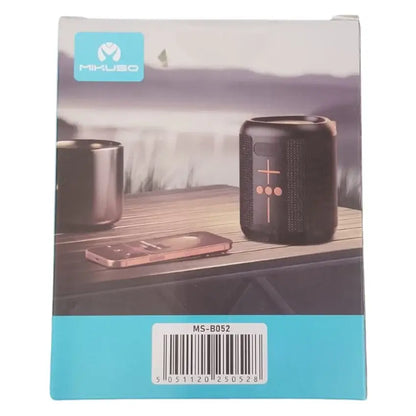 Mikuso MS-B052 portable Bluetooth speaker box packaging, featuring a black speaker and a smartphone on a wooden deck with a scenic lake background.
