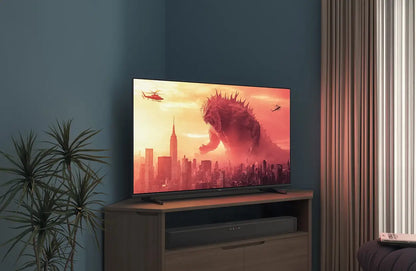 TV displaying a Godzilla movie scene in a living room setting