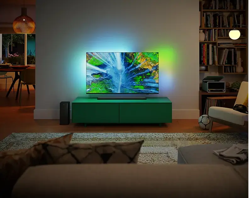 Living room with a green TV stand and a television displaying a nature scene.