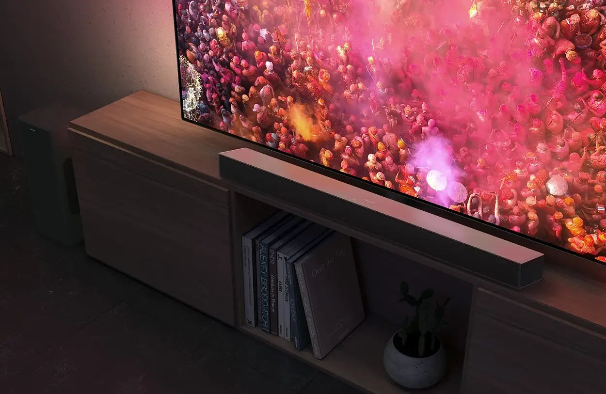 Modern living room with a large flat-screen TV on a wooden stand displaying colorful content.