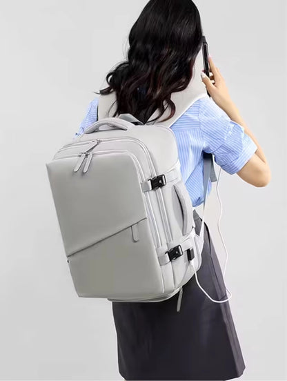 Person wearing a beige backpack on a plain background
