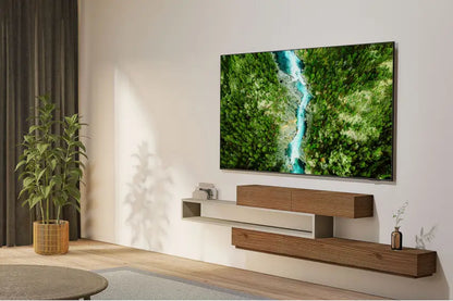 Modern living room with a Samsung 50" U8000F Crystal UHD 4K Smart TV displaying a nature scene, wooden entertainment console, and decorative plants.
