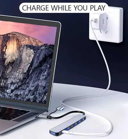 Laptop with USB hub connected to a power outlet with 'Charge While You Play' text.